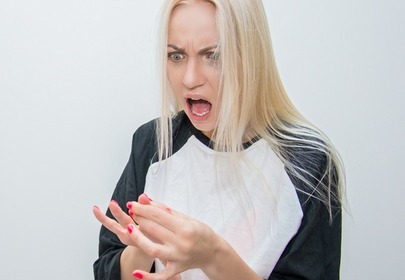 Dziewczyna w długich blond włosach patrzy na paznokcie i krzyczy Dziewczyna w długich blond włosach patrzy na paznokcie i krzyczy